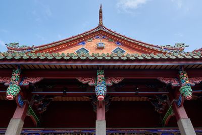 Low angle view of temple and building against sky