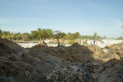 Panoramic view of rocks on land against sky