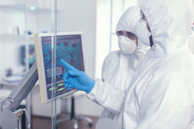 Midsection of scientist working in laboratory