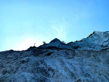 Scenic view of snowcapped mountain against blue sky