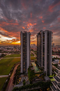 Illuminated buildings against sky during sunset