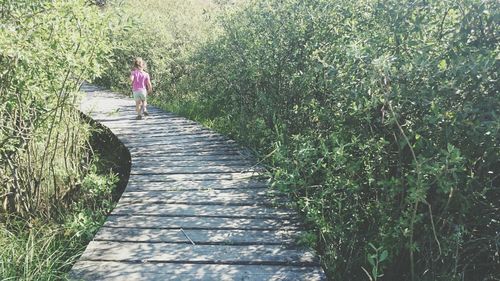 Woman walking on footpath