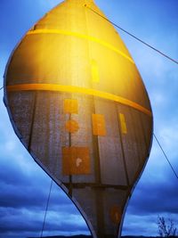 Low angle view of yellow umbrella against sky