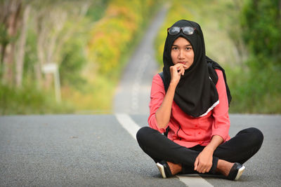 Young woman sitting outdoors