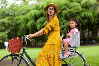 Portrait of smiling woman riding bicycle