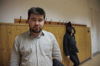 Portrait of young man standing against wall