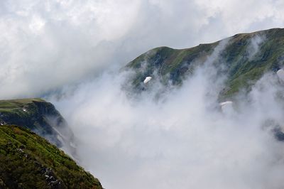 Scenic view of waterfall against sky