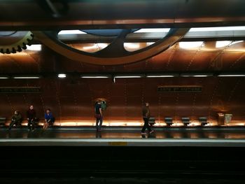 People at railroad station platform at night