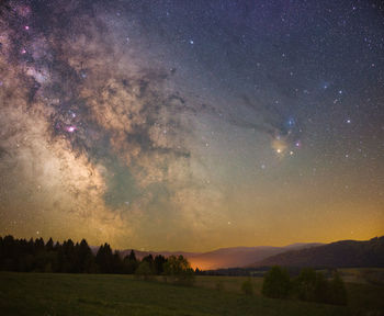 Sky with stars and milky way over scenic landscape 