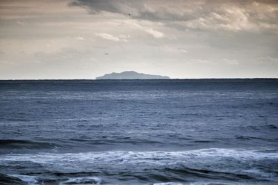 Scenic view of sea against cloudy sky