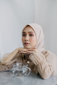 Portrait of young woman looking at table