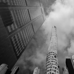 Low angle view of buildings against cloudy sky