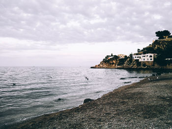 Scenic view of sea against cloudy sky