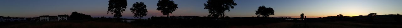 Panoramic shot of silhouette trees against sky at sunset