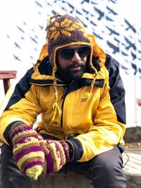 Midsection of man sitting in snow