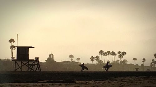 People on horse against clear sky