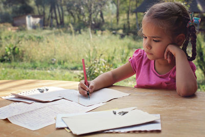 Boy drawing on book