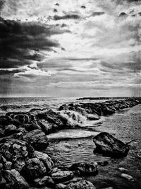 Scenic view of sea against cloudy sky