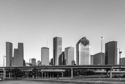 Modern buildings in city against clear sky