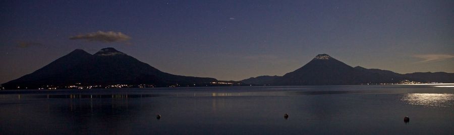 Scenic view of lake against sky at night