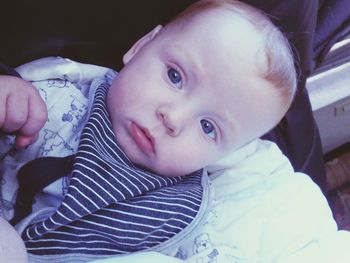 Close-up portrait of boy lying at home