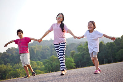 Portrait of smiling family walking on road