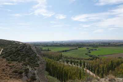 Scenic view of agricultural landscape against sky