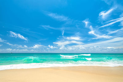 Scenic view of beach against blue sky