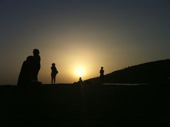 Silhouette of people at sunset