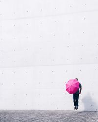 Full length of young woman standing by railing