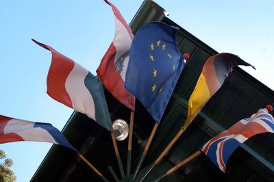 Low angle view of flags against clear sky