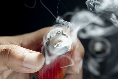 Close-up of man smoking electronic cigarette