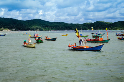 Boats moored in sea against sky