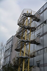 Low angle view of building against cloudy sky