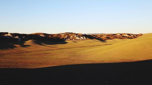 Scenic view of desert against clear sky