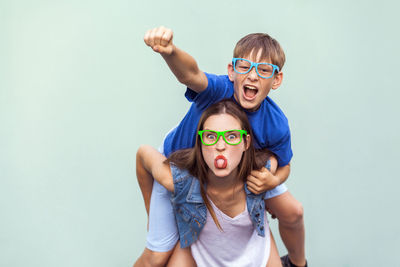 Portrait of father and son against white background