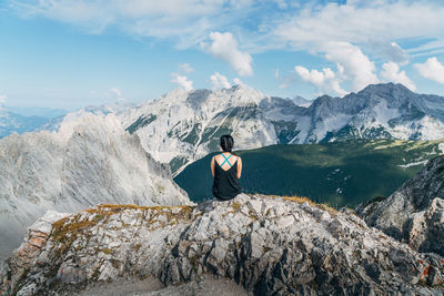 Rear view of woman walking on snow covered mountain