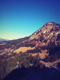 Scenic view of mountains against clear blue sky