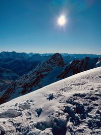 Scenic view of snow covered mountains against sky