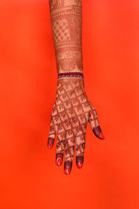 Close-up of woman against red background