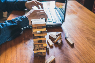 High angle view of man sitting on wooden table