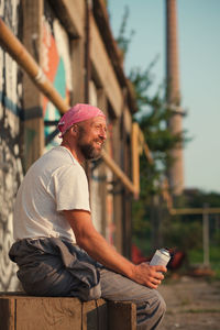 Midsection of man using mobile phone outdoors