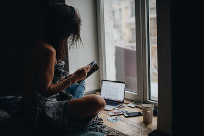 Woman using mobile phone at home