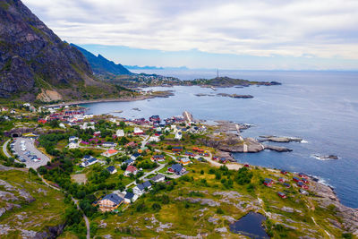 High angle view of townscape by sea against sky