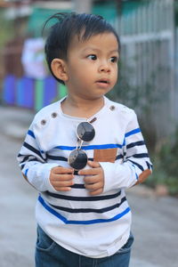 Asian boys wearing black fashion glasses and white striped shirts.