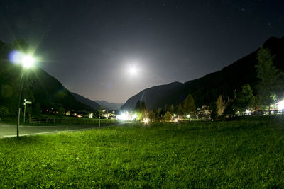 Scenic view of illuminated mountains against clear sky at night