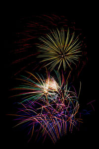 Low angle view of firework display at night