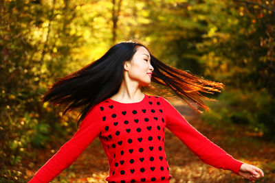 Woman with tousled hair in forest