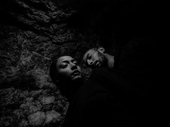 Portrait of mother and son on rock