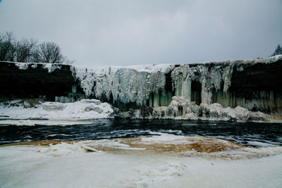 Scenic view of frozen lake against sky during winter